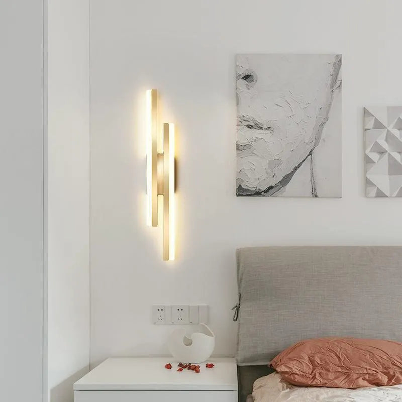 Scandinavian minimalist LED wall light with acrylic shade on black or gold arm.