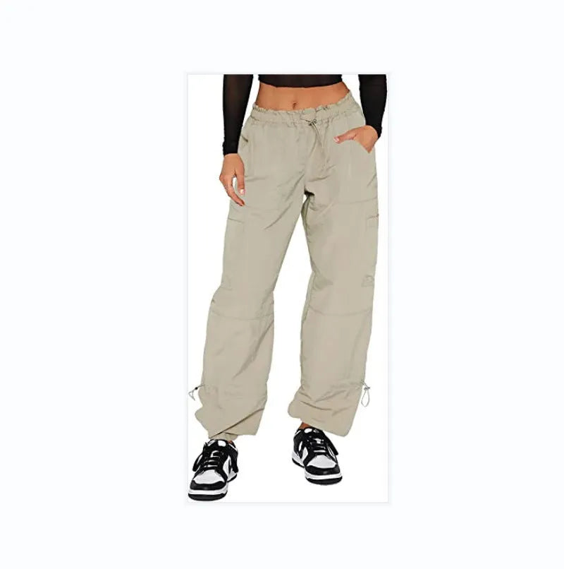 Loose-fit straight-leg cargo casual trousers in grey on a model, showing multiple pockets and mid-rise waist.