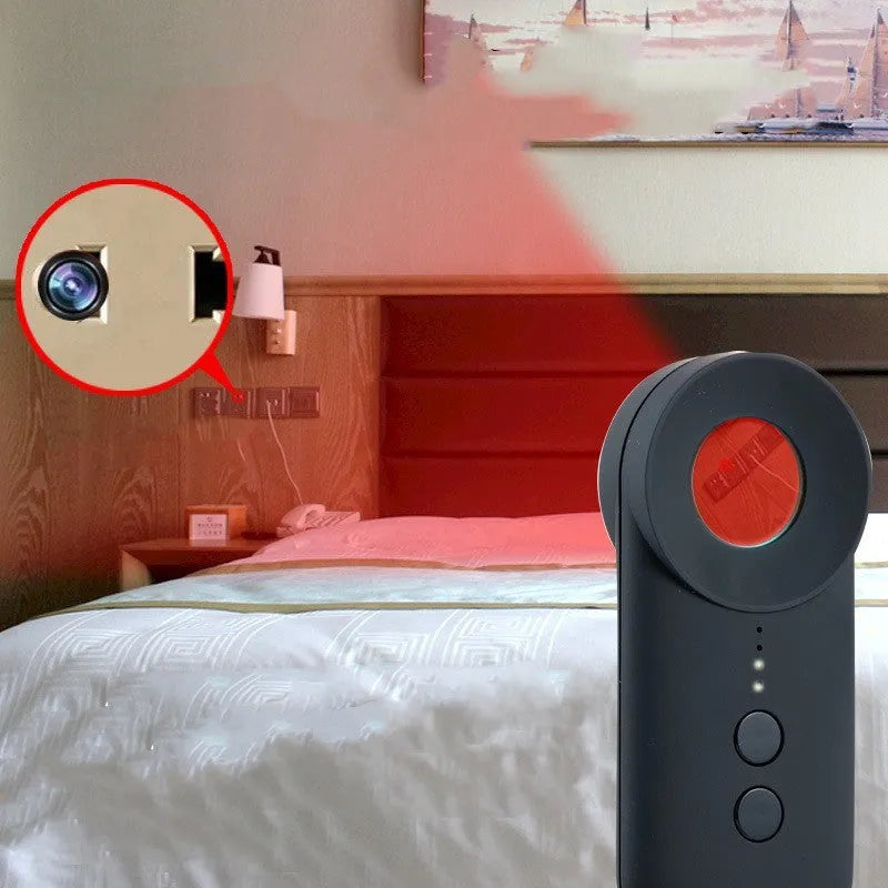 Black portable GPS and WiFi signal detector with laser scanner for hidden cameras on a table.