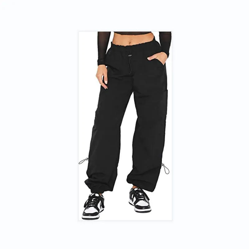 Loose-fit straight-leg cargo casual trousers in grey on a model, showing multiple pockets and mid-rise waist.