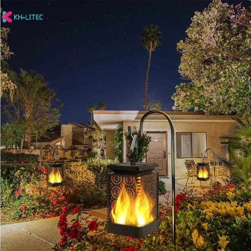 Set of four black solar-powered LED lanterns with flickering flame effect for garden paths.