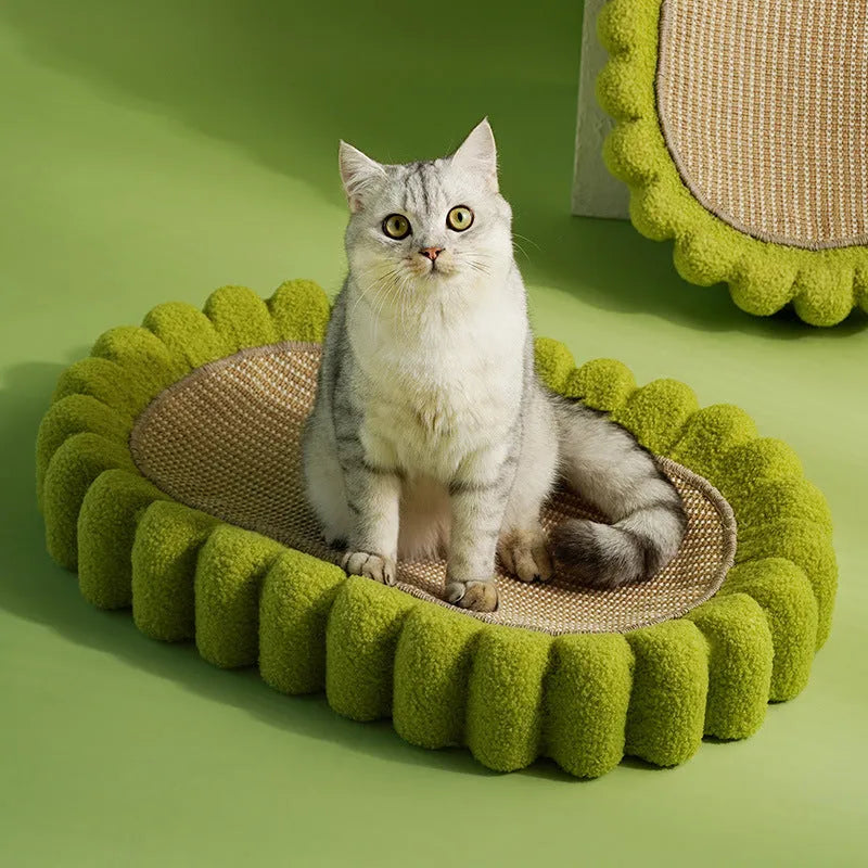 Green oval cat scratcher pad and bed made from sisal, measuring 65cm long.
