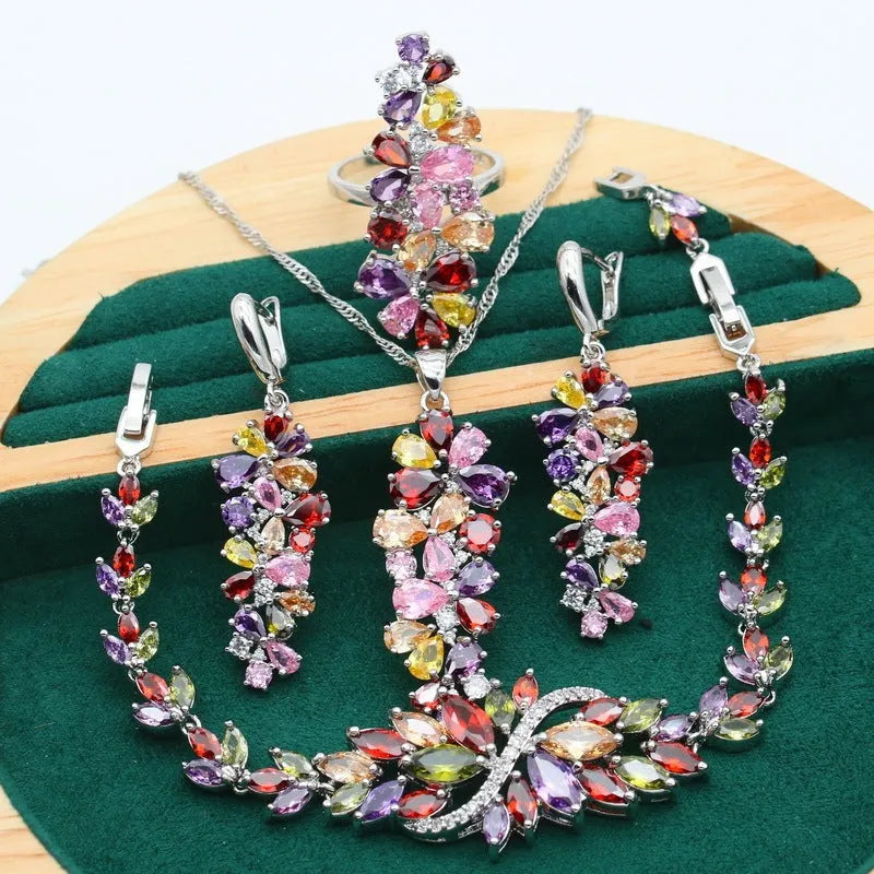 Retro jewellery set with plants and flowers design showing necklace, earrings, ring and bracelet in olive purple colours