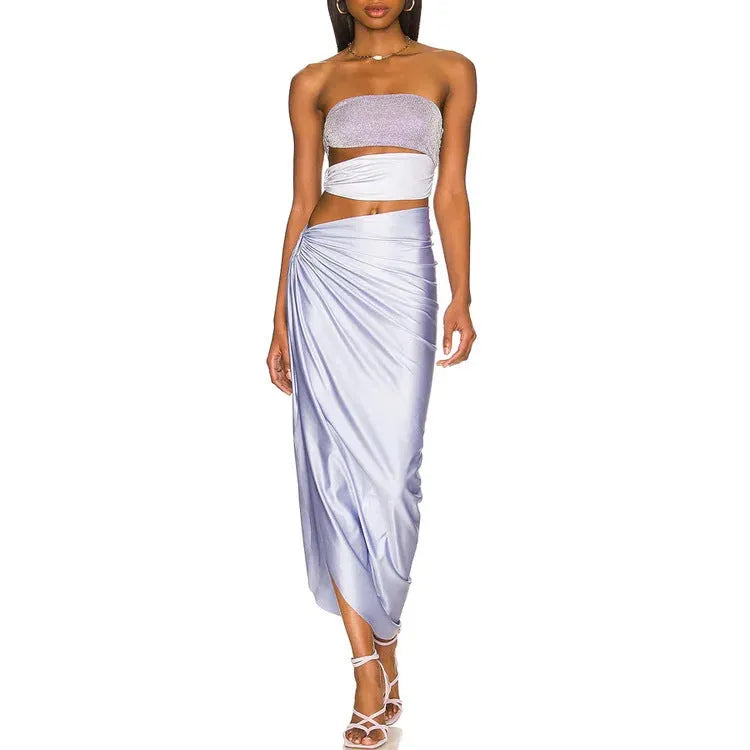 Purple one-piece swimsuit with hollow back and matching wrap skirt laid flat.