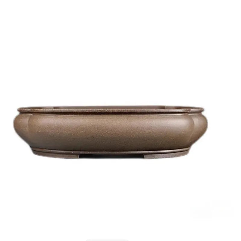 Handmade antique purple clay papaya-shaped flower pot on a tabletop