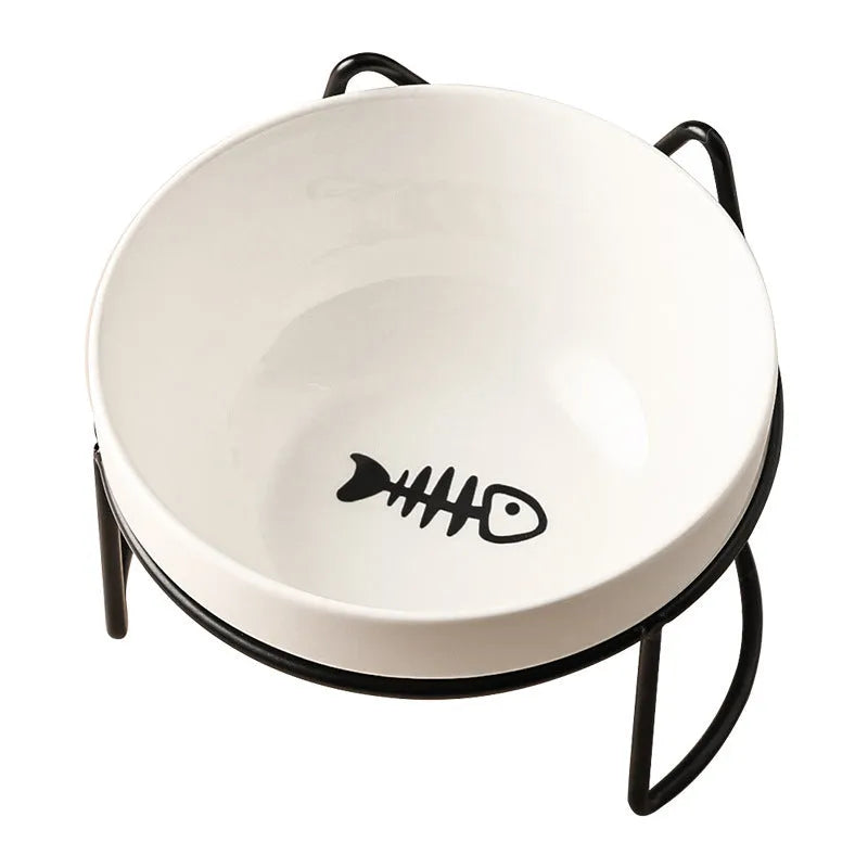 White ceramic cat food bowl with cat paw print design on black iron frame stand