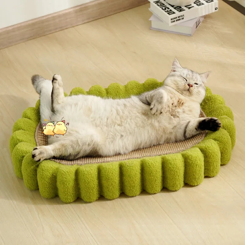Green oval cat scratcher pad and bed made from sisal, measuring 65cm long.