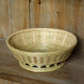 Handmade natural bamboo storage basket shown in a household setting.