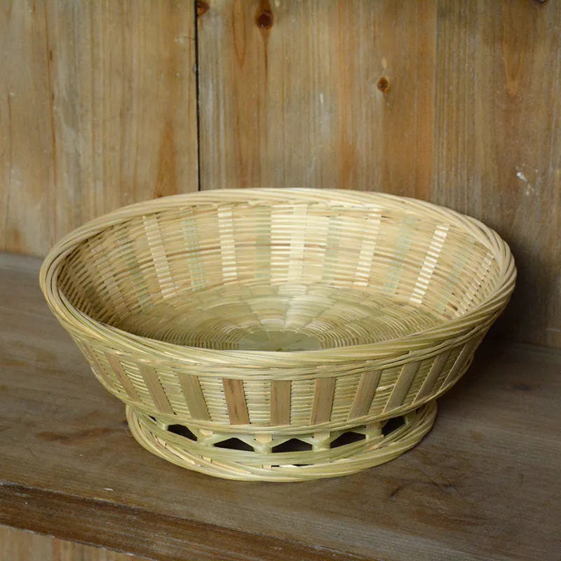 Handmade natural bamboo storage basket shown in a household setting.