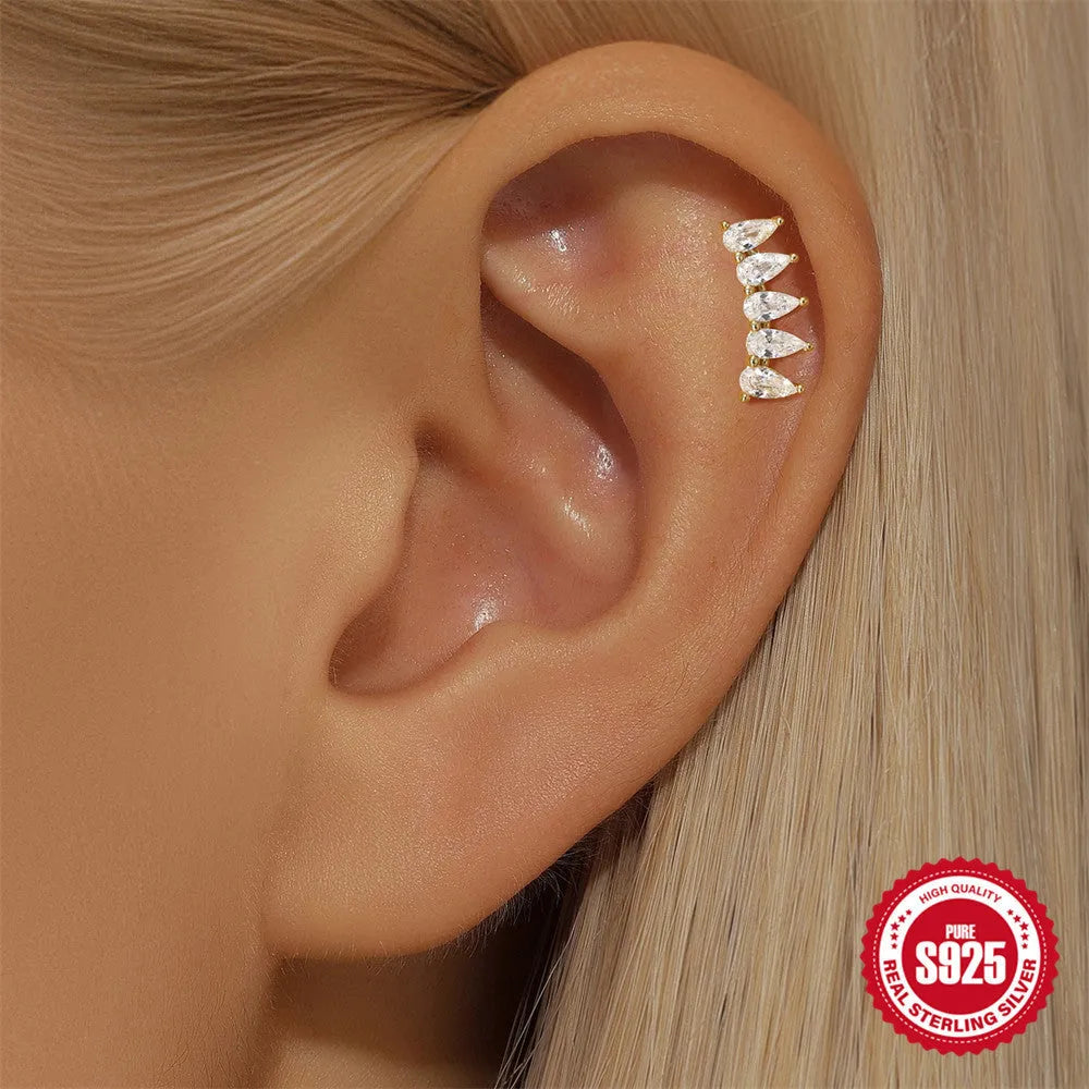 S925 sterling silver geometric moon and embedded star piercing earrings on a gold-colour background.