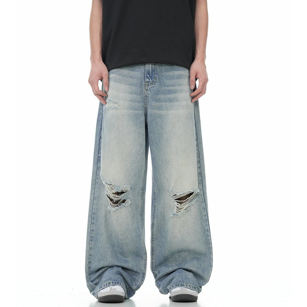 Blue men's straight-leg jeans with ripped distressing detail on the legs.
