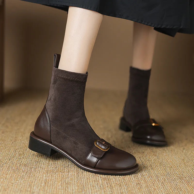 Women's black casual Martin-style ankle boots with buckle stitching and front lace-up on a low rubber sole.