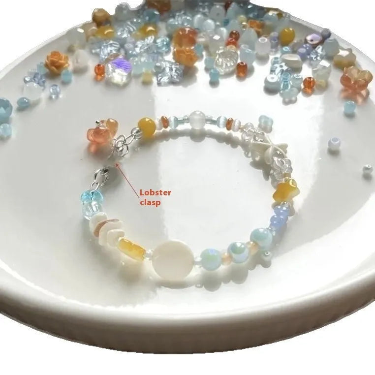 Mixed material alloy bracelet with diamond elements and round detailing in Orange Sea Summer colour