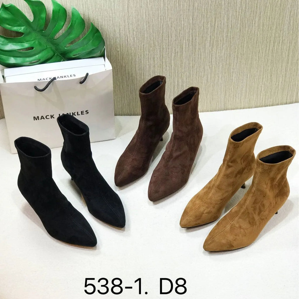 Black pointed toe women's ankle boots with a stiletto heel on a white background.
