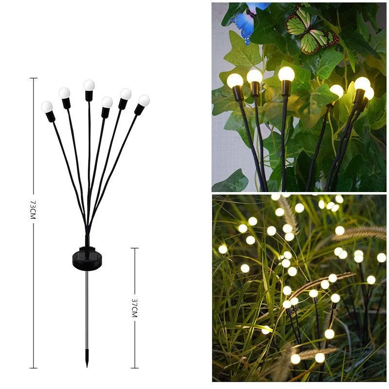 Solar-powered LED firefly garden spike light with stainless steel ground stake illuminated at dusk.