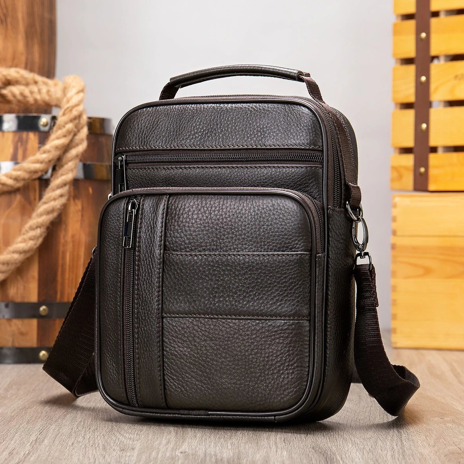 Vintage brown cowhide leather men's shoulder bag showing vertical square shape and front zipper.