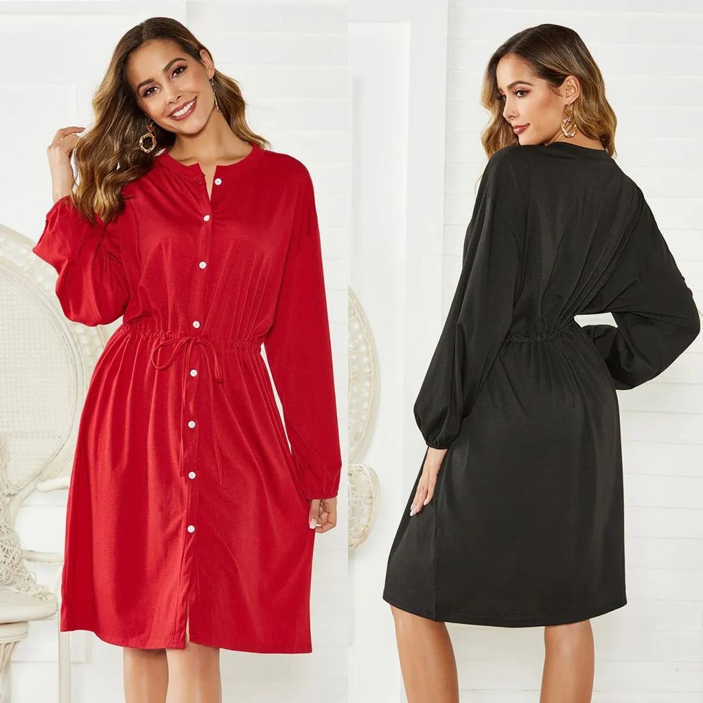 Black or red A-line mid-length dress with elastic waist, long sleeves with elastic cuffs, and a loose cinching belt.