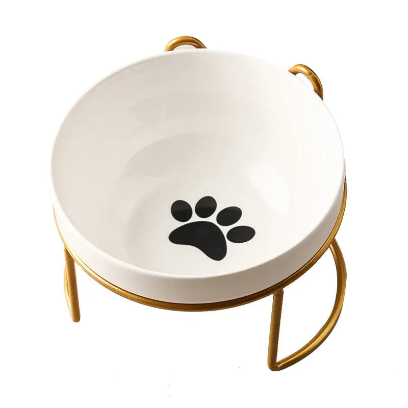 White ceramic cat food bowl with cat paw print design on black iron frame stand