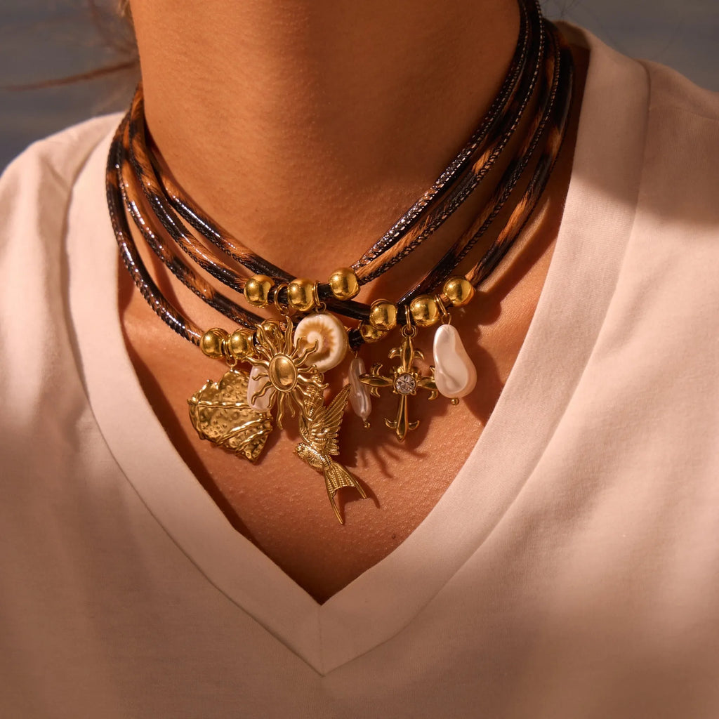 Gold plated stainless steel necklace with geometric leopard pendant and adjustable chain on white background