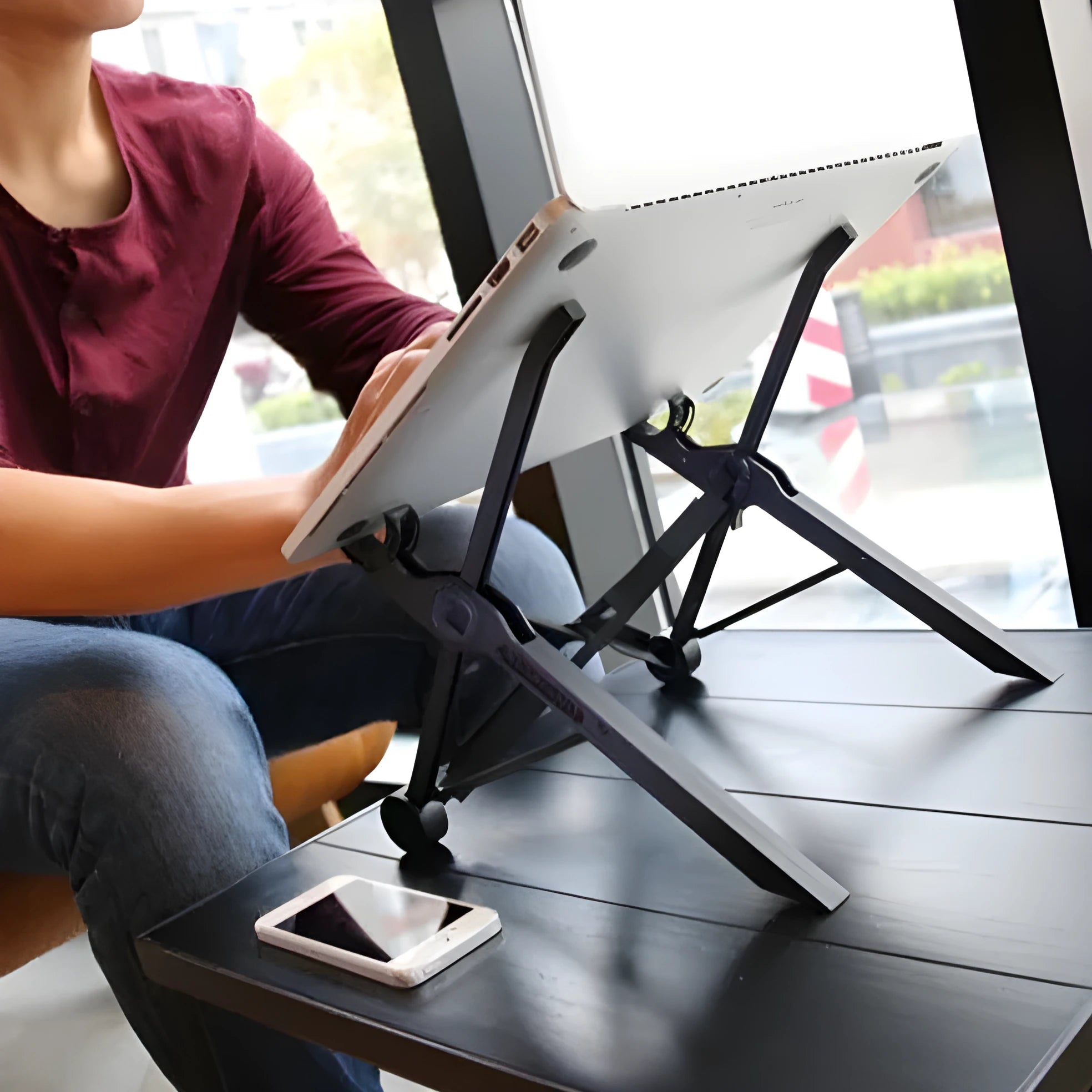 Sagacious black portable folding laptop bracket with carrying case showing lifting mechanism