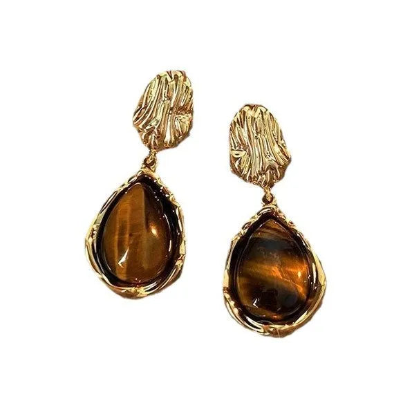 A set of three handmade geometric tassel earrings for women: Amber, round piece, and water drop styles.