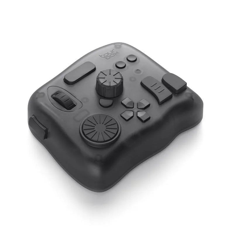 TourBox NEO black creative controller for video editing on a desk next to a tablet.