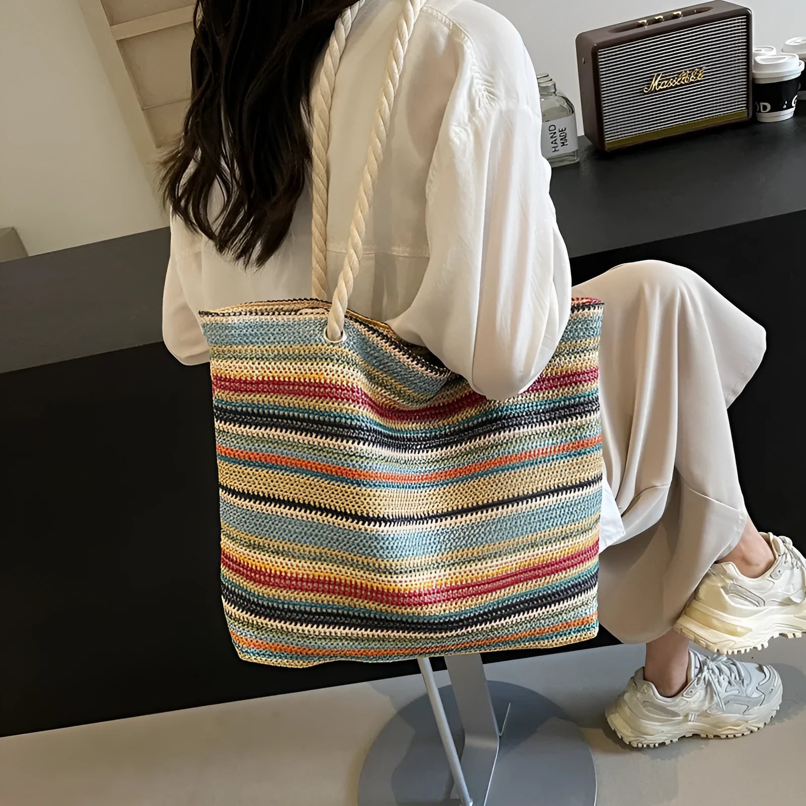 Blue woven straw-effect nylon shoulder bag with a single strap and large main compartment.