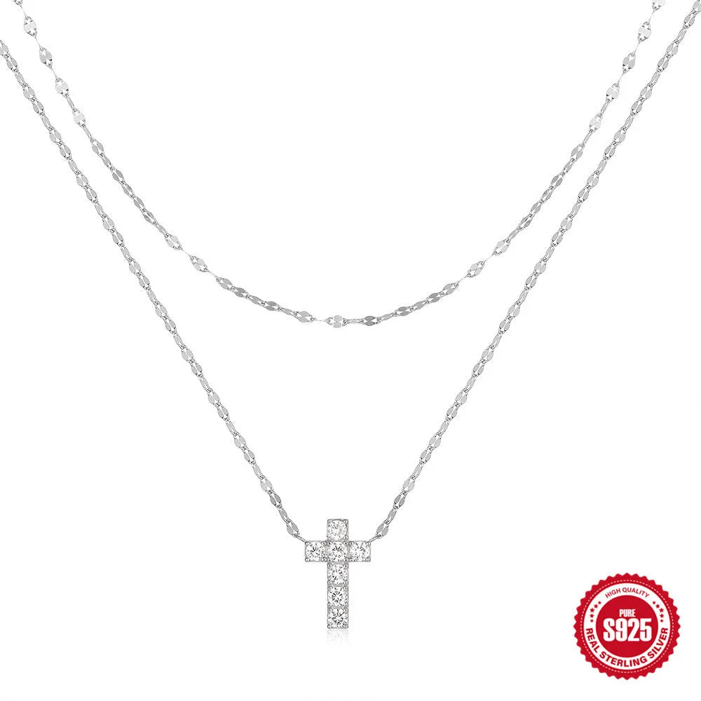 Sterling silver geometric cross pendant necklace with double layer design and diamond detailing on clavicle chain