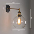 20cm round retro glass wall lamp in amber colour with aluminium holder on a white wall.