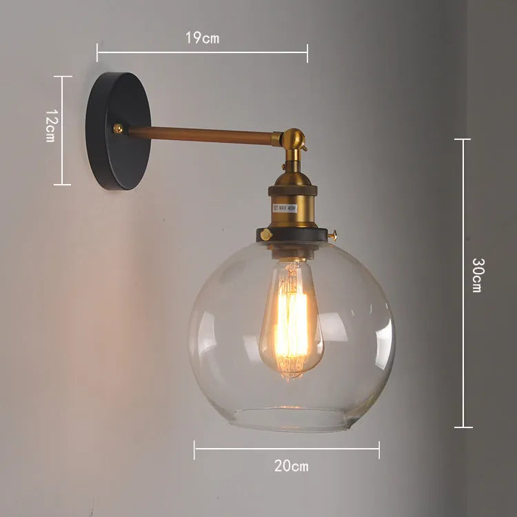 20cm round retro glass wall lamp in amber colour with aluminium holder on a white wall.