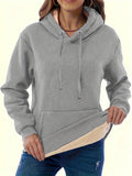 Women's thick grey hooded sweater with a 3D pattern and front pockets on a hanger.