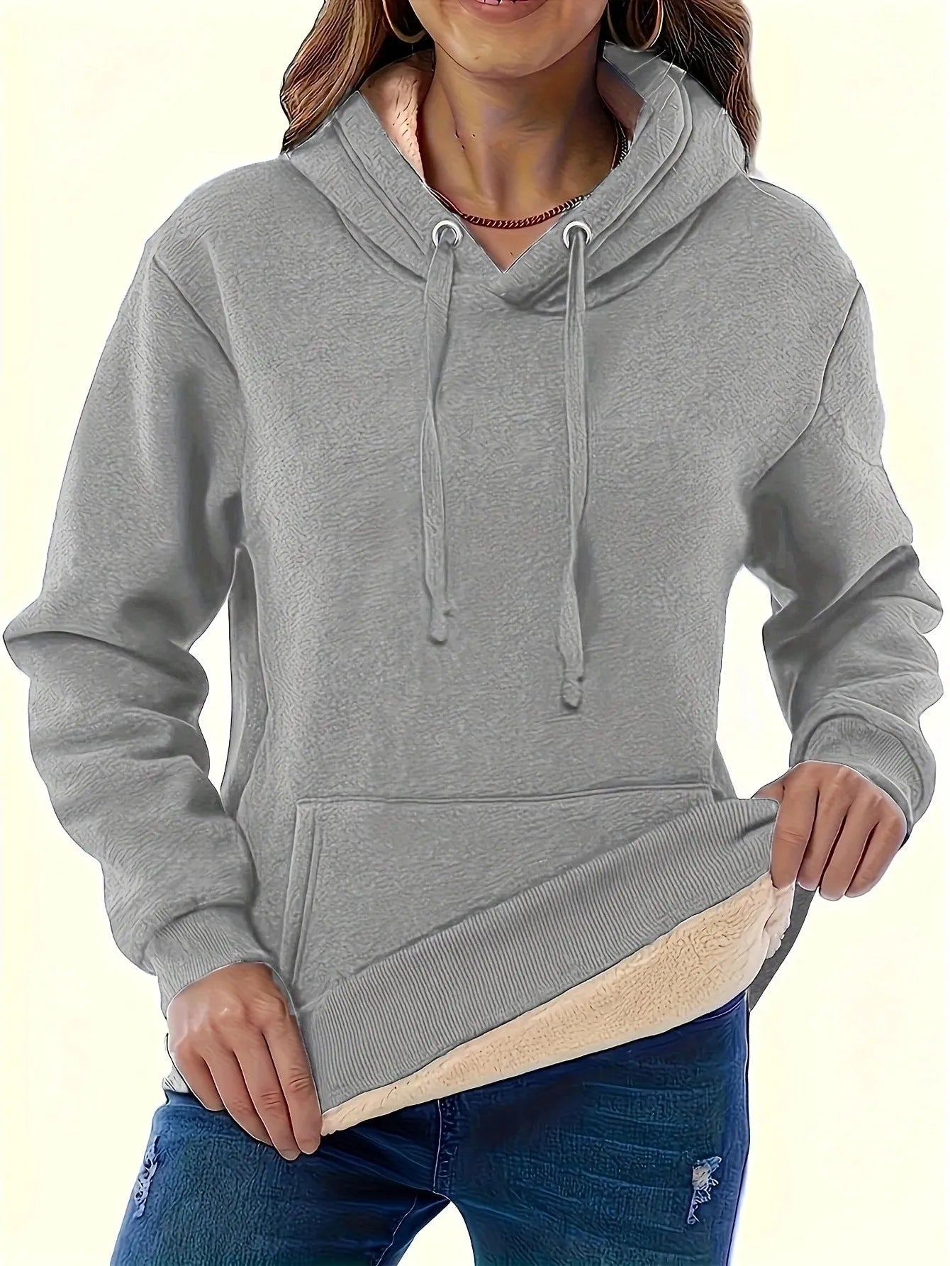 Women's thick grey hooded sweater with a 3D pattern and front pockets on a hanger.