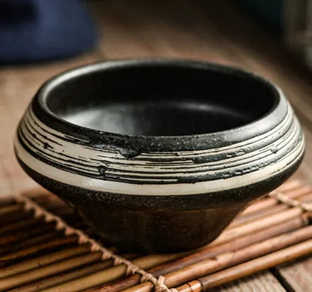 Ceramic tall Japanese soup noodle bowl in a retro glaze colour on a wooden table.