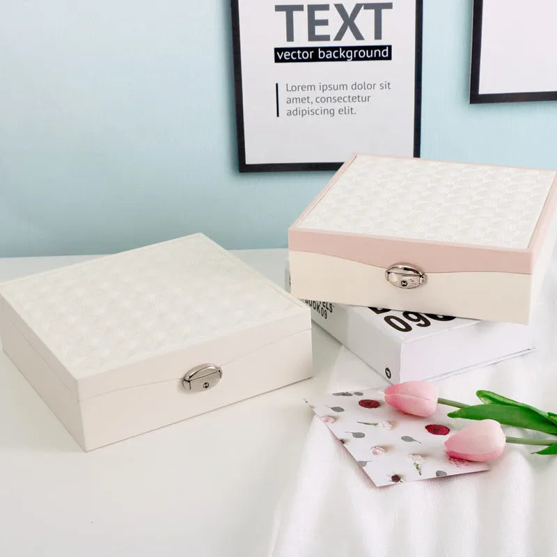 Red and white jewellery storage box with compartments for necklaces and rings