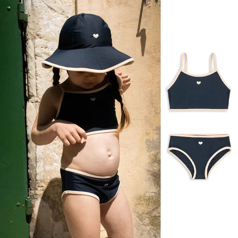 Dark blue split colour baby girls' swim briefs made from polyester and Lycra fabric.