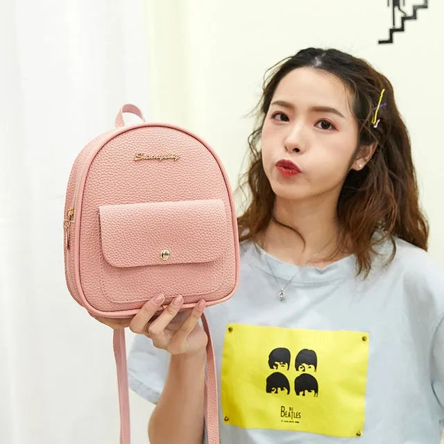Women's small PU backpack shoulder bag in black, blue, grey, pink, or red with zipper closure