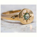 Gold ring with star-shaped asterism pattern and adjustable opening.