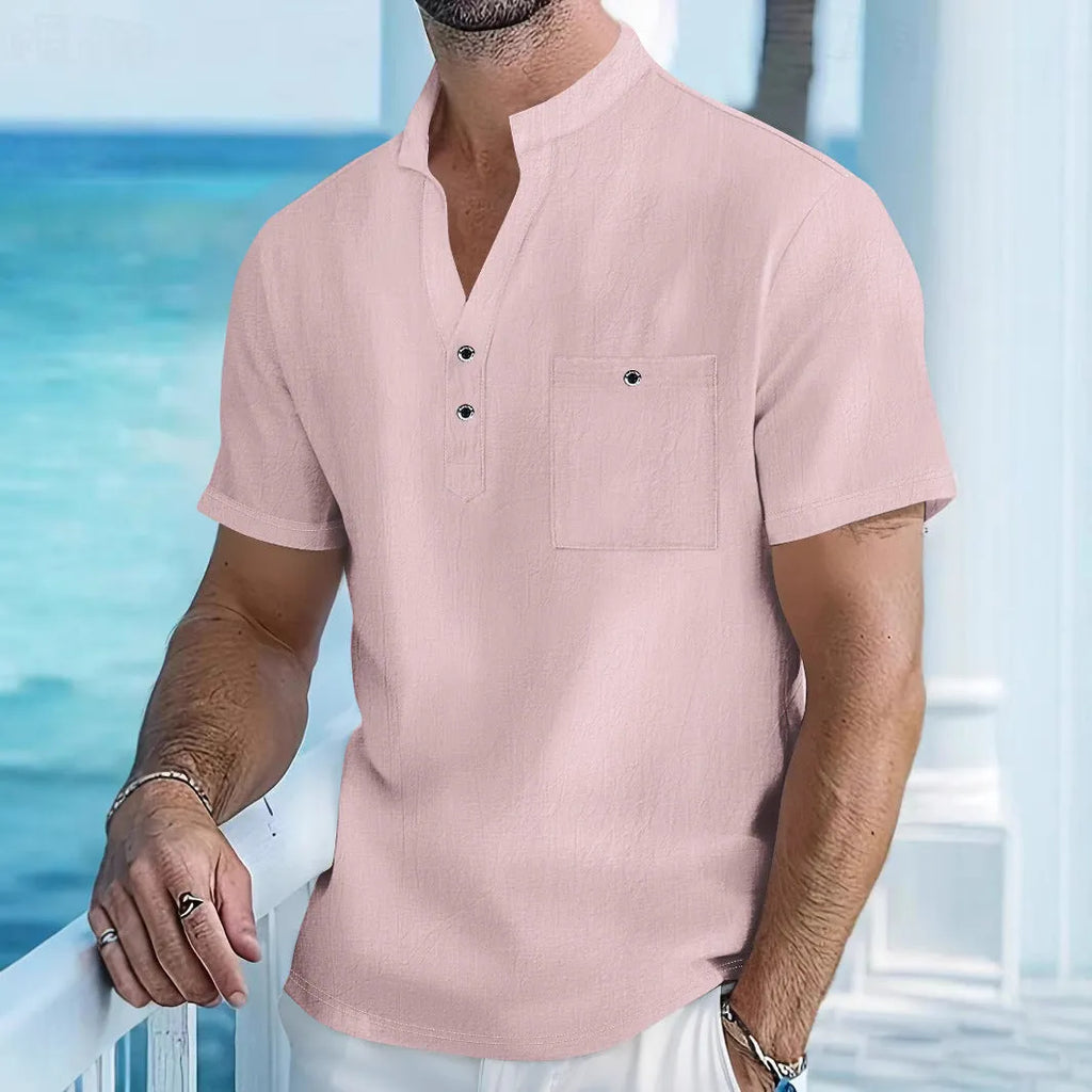 Man wearing a light apricot-coloured linen stand collar T-shirt with short sleeves and a loose fit.