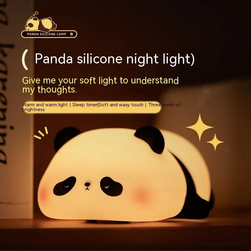 Cartoon panda-shaped silicone night light for kids on a bedside table.