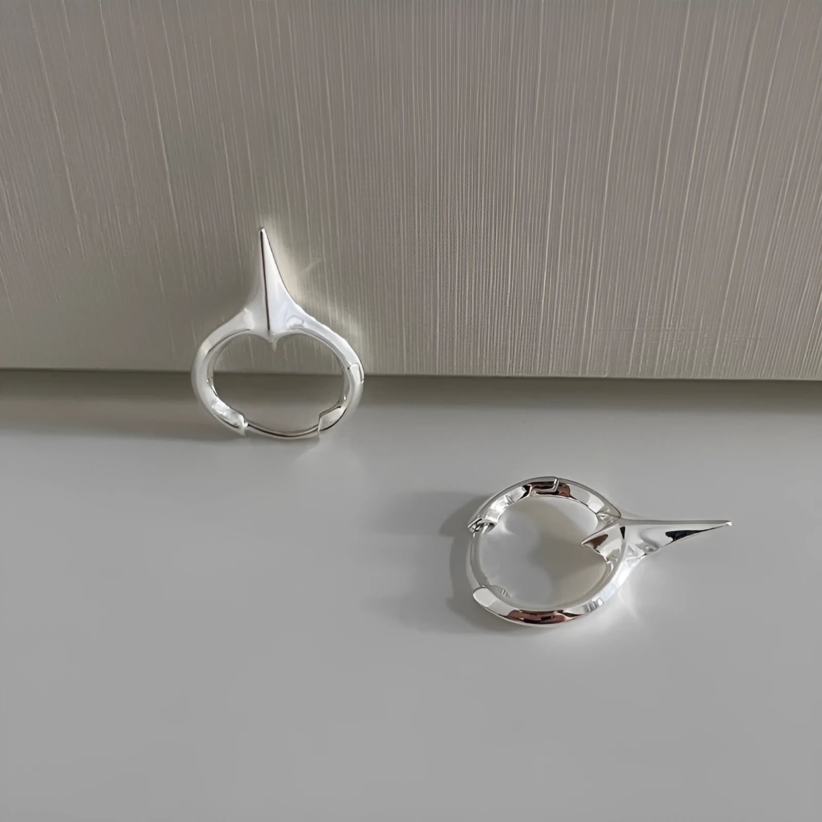 Geometric star-shaped ear clips with electroplated platinum finish on copper construction