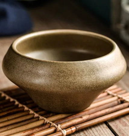 Ceramic tall Japanese soup noodle bowl in a retro glaze colour on a wooden table.