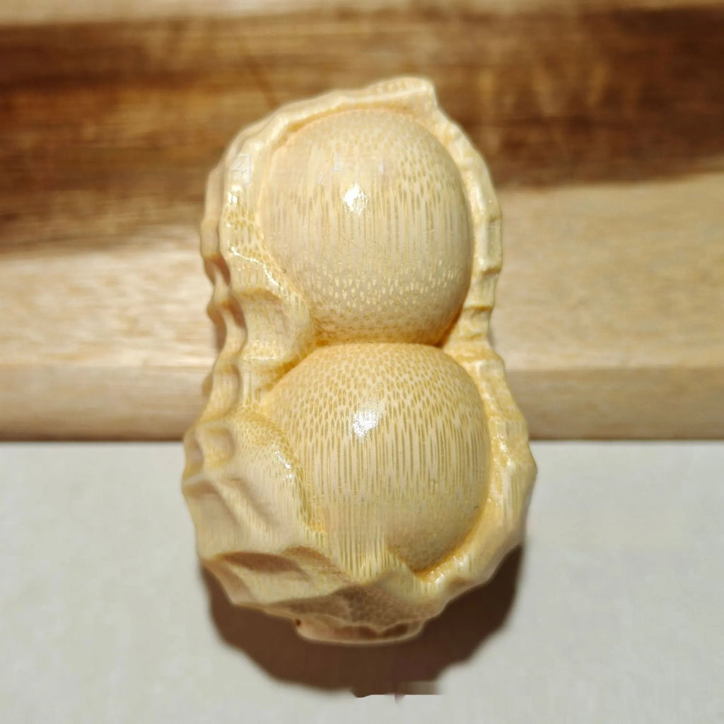 Solid natural bamboo peanut ornament with 'good things may happen' engraved message.