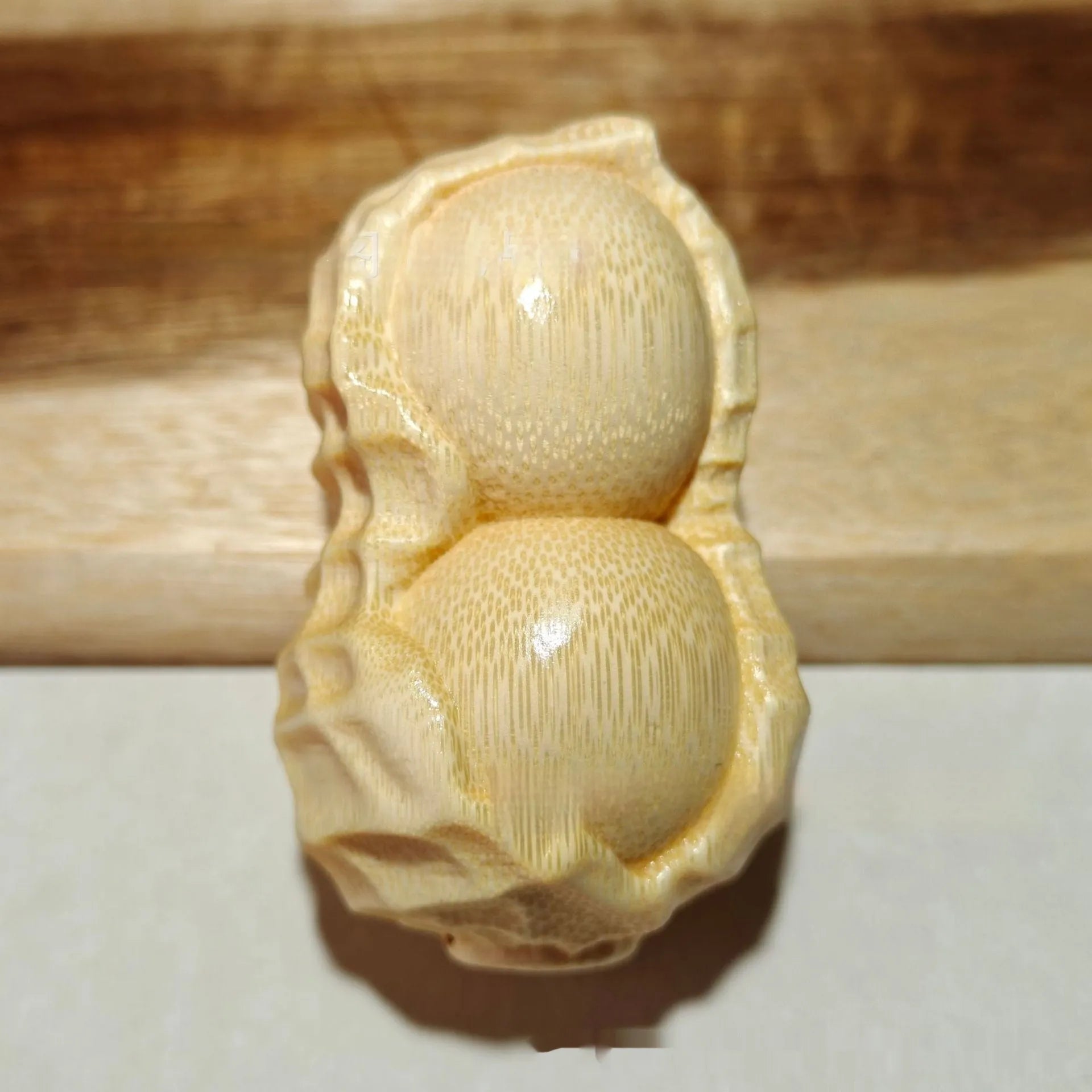 Solid natural bamboo peanut ornament with 'good things may happen' engraved message.