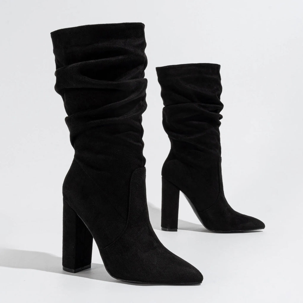 Black suede women's boots with a pointed toe and a thick chunky high heel, mid-calf length.