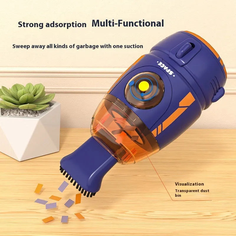 Handheld USB desktop vacuum cleaner in blue rocket design on a wooden desk.