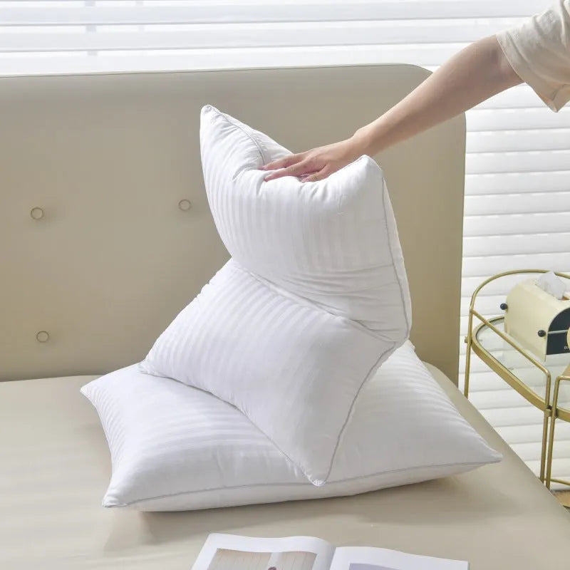 White satin stripe feather and cotton pillow shown in three different size options.