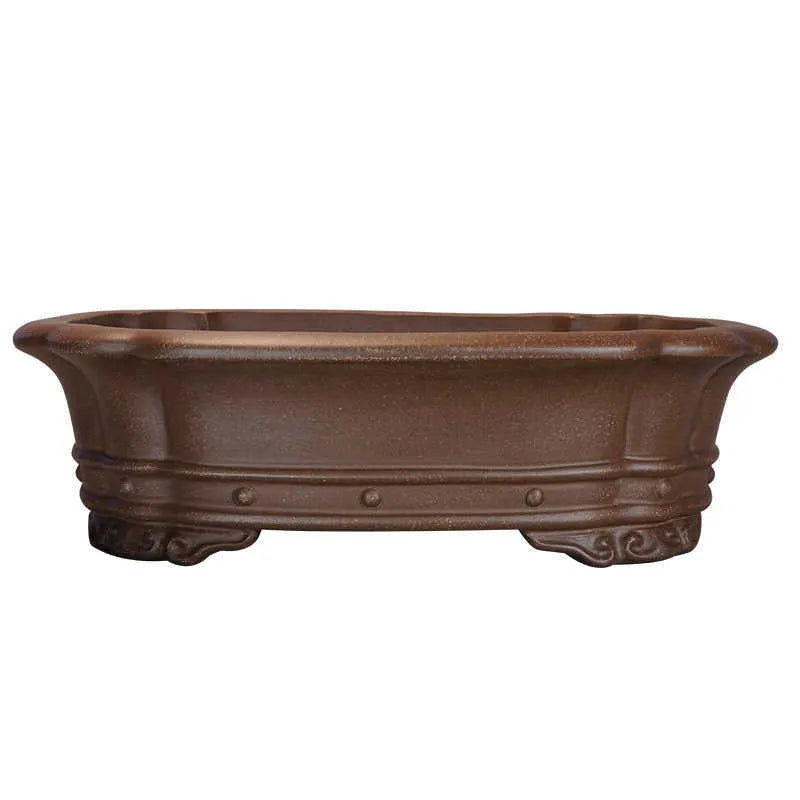 Purple clay handmade rectangular antique flower pot on a desktop.