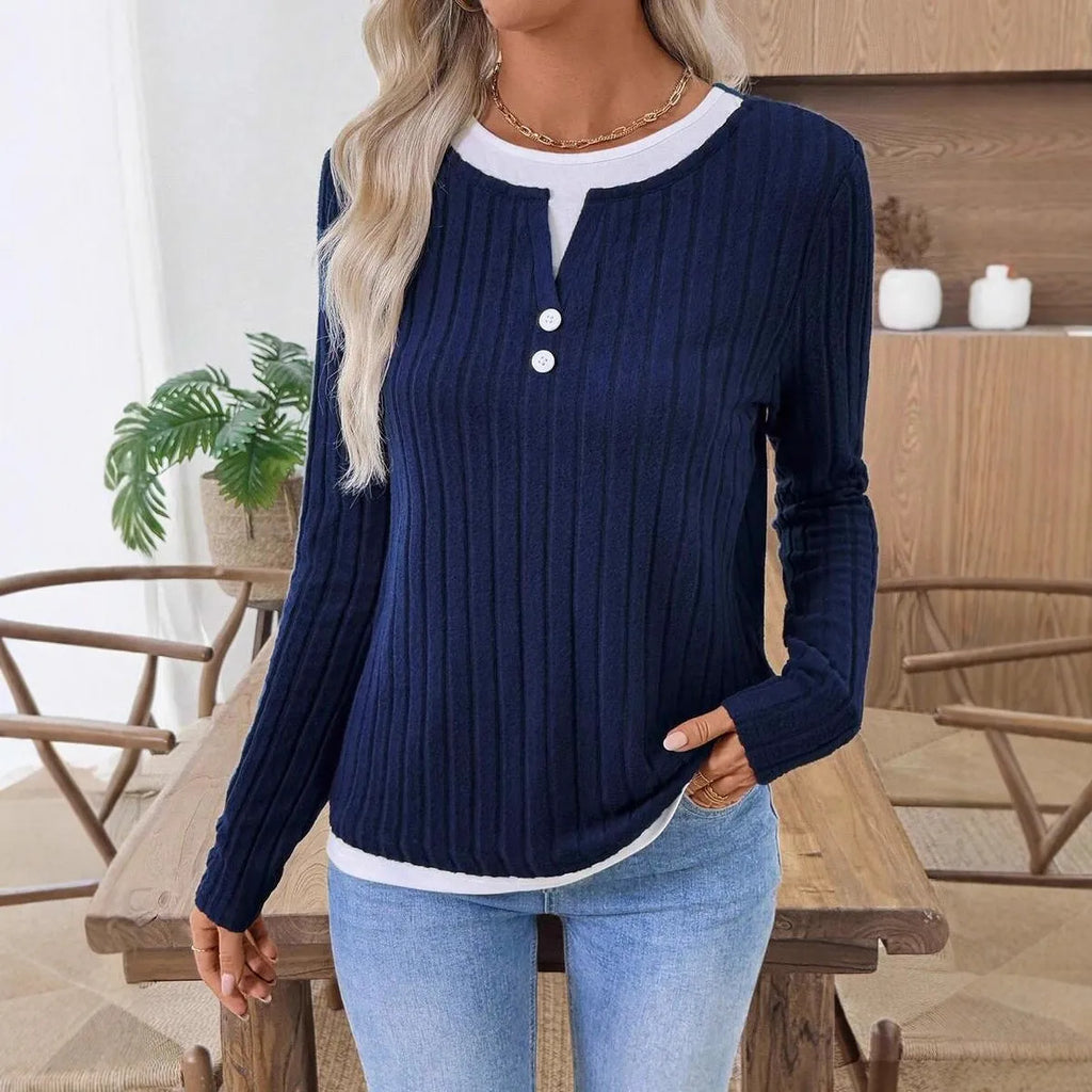 Women's black grinding stripe fake two-piece pullover sweater with round neck and button detail.