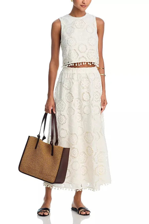 White women's sleeveless top and long skirt suit with embroidery detail