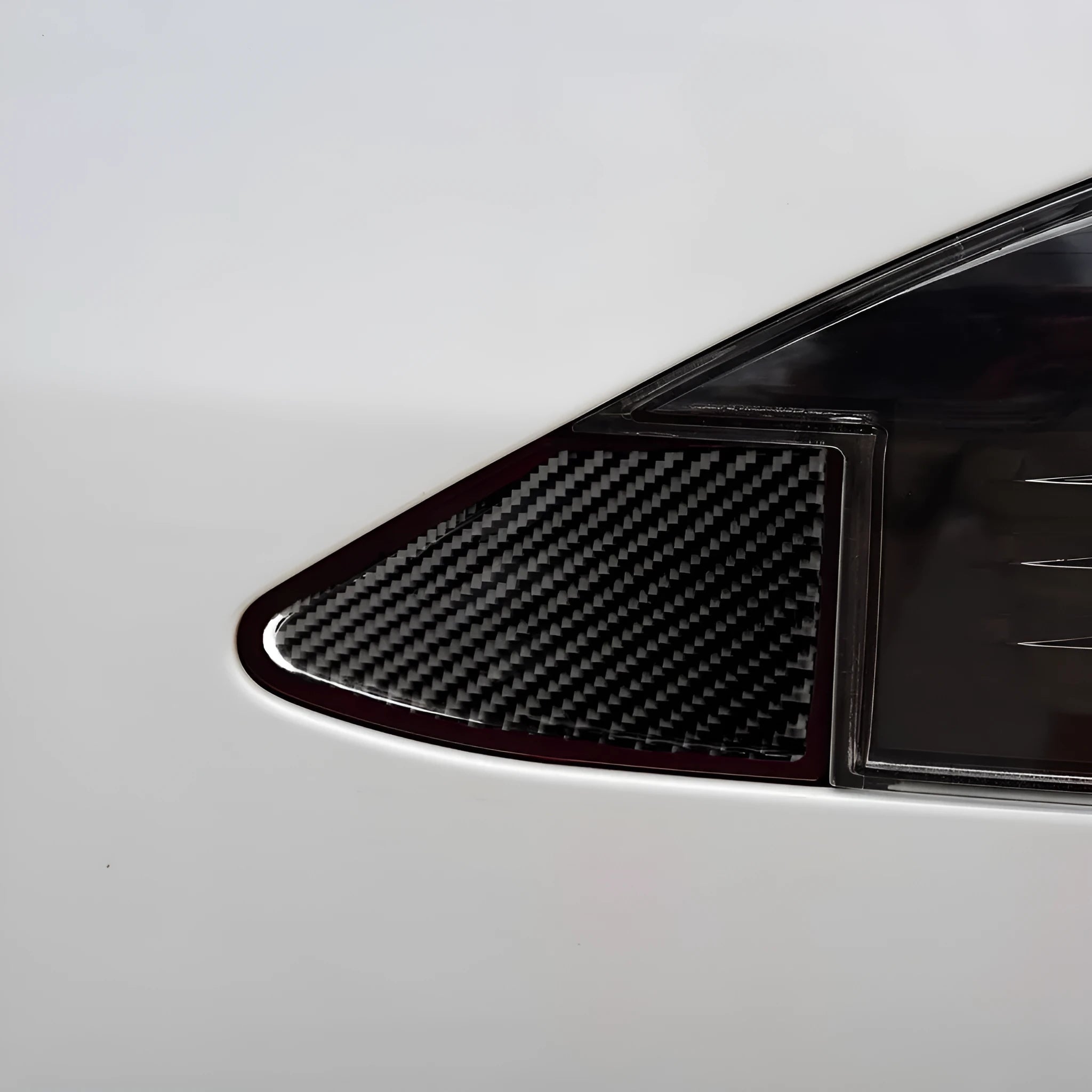 Carbon fibre textured sticker for covering a device charging port panel, showing the 3M adhesive backing.